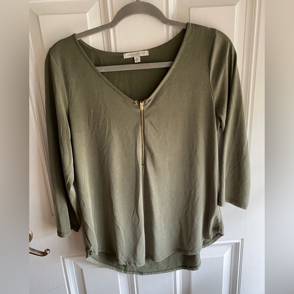 Olive green blouse with the gold zipper detail